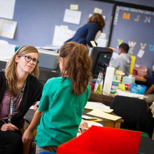 A teacher is listening to her student.